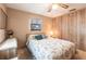 Cozy bedroom features a ceiling fan, and wood paneled accent wall at 1851 Scenic Dr, Venice, FL 34293