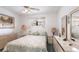 Bedroom with ceiling fan, decorative trim, and twin dresser at 1851 Scenic Dr, Venice, FL 34293