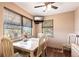 Bright and airy dining area with a TV, large windows, and seating for six at 1851 Scenic Dr, Venice, FL 34293