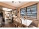 Eat in kitchen area featuring white table with seating and large windows at 1851 Scenic Dr, Venice, FL 34293