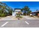 Contemporary two-story home featuring a unique architectural design with a garage and well-kept yard at 1851 Scenic Dr, Venice, FL 34293