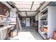 Functional garage space is perfect for storage or workshop, complete with shelving and work area at 1851 Scenic Dr, Venice, FL 34293