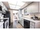 Charming kitchen with ample cabinet space and black appliances, offering style and function at 1851 Scenic Dr, Venice, FL 34293