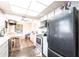 Cozy kitchen with black appliances, stone floors, and an adjacent dining area at 1851 Scenic Dr, Venice, FL 34293