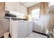 Convenient laundry room equipped with washer, dryer, and ample cabinet space for storage at 1851 Scenic Dr, Venice, FL 34293