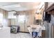 Practical laundry area featuring a utility sink, storage cabinets, and hanging space at 1851 Scenic Dr, Venice, FL 34293