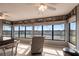 Bright sunroom with a wall of windows, offering panoramic views and filled with natural light at 1851 Scenic Dr, Venice, FL 34293