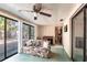 Relaxing sunroom offers plenty of natural light, a ceiling fan, and outdoor views at 1851 Scenic Dr, Venice, FL 34293