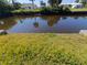 A view of the backyard canal features a grassy lawn at 190 Danforth Dr, Punta Gorda, FL 33980