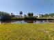A view of the backyard canal features a grassy lawn at 190 Danforth Dr, Punta Gorda, FL 33980