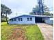 Charming single-story home with a covered carport and well-maintained landscaping on a partially cloudy day at 190 Danforth Dr, Punta Gorda, FL 33980