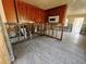 Kitchen in progress, showing wood cabinets, exposed wall studs, and new tile flooring at 190 Danforth Dr, Punta Gorda, FL 33980