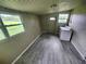 A laundry room features gray floors, two windows, and a washing machine at 190 Danforth Dr, Punta Gorda, FL 33980