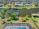 Scenic aerial view of a canal-front property with a pool, dock, and lush landscaping at 21169 Edgewater Dr, Port Charlotte, FL 33952