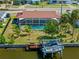 Waterfront home featuring a screened pool and a boat dock with a lift for easy water access at 21169 Edgewater Dr, Port Charlotte, FL 33952
