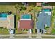 Birds eye view of backyard and neighboring properties, two with pools, and three car driveways at 21169 Edgewater Dr, Port Charlotte, FL 33952