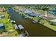 Aerial view of waterfront home with private boat dock and lift with easy access to open water at 21169 Edgewater Dr, Port Charlotte, FL 33952