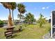 Relaxing backyard oasis with a custom-made wood table, canal view and lush green space at 21169 Edgewater Dr, Port Charlotte, FL 33952