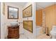 Elegant bathroom featuring a vessel sink, ornate vanity, and decorative artwork at 21169 Edgewater Dr, Port Charlotte, FL 33952