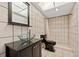 Modern bathroom features tiled shower, unique vessel sink, and contemporary black toilet at 21169 Edgewater Dr, Port Charlotte, FL 33952