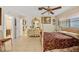 Spacious bedroom with a four-poster bed, tiled floors, and ornate vanity with large mirror at 21169 Edgewater Dr, Port Charlotte, FL 33952