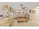Bedroom with a four-poster bed, tiled floors, ceiling fan, and ornate decor at 21169 Edgewater Dr, Port Charlotte, FL 33952