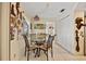 Cozy dining area featuring a glass-top table, decorative art, and tiled flooring at 21169 Edgewater Dr, Port Charlotte, FL 33952
