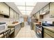 Galley kitchen features tiled floors, matching countertops, and ample cabinet storage at 21169 Edgewater Dr, Port Charlotte, FL 33952