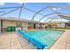 Enclosed screened pool with a covered pool cover, perfect for relaxation and recreation at 21169 Edgewater Dr, Port Charlotte, FL 33952