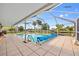 Relaxing screened-in pool area with tiled deck, perfect for enjoying the Florida sunshine at 21169 Edgewater Dr, Port Charlotte, FL 33952