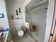 Well-lit bathroom with a toilet and a shower stall with glass sliding doors and white tile at 21342 Walling Ct, Port Charlotte, FL 33954