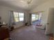 Bright bedroom with vaulted ceiling and a sliding glass door that leads to a screened porch at 21342 Walling Ct, Port Charlotte, FL 33954