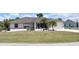 Charming single-story home with well-maintained lawn and tropical landscaping showcasing curb appeal at 21342 Walling Ct, Port Charlotte, FL 33954