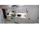 Bright kitchen with white cabinetry, tiled flooring, and modern appliances, perfect for culinary enthusiasts at 21342 Walling Ct, Port Charlotte, FL 33954