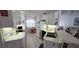Efficient kitchen with a breakfast bar, white cabinets, and neutral countertops for a clean, functional space at 21342 Walling Ct, Port Charlotte, FL 33954