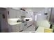 Well-lit kitchen featuring white appliances, ample cabinet space, and tile flooring at 21342 Walling Ct, Port Charlotte, FL 33954
