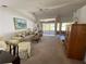 Spacious living room with neutral carpet, ceiling fan, and large windows letting in natural light at 21342 Walling Ct, Port Charlotte, FL 33954