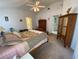 Bright main bedroom with a ceiling fan, carpeted floors, and access to ensuite bathroom at 21342 Walling Ct, Port Charlotte, FL 33954