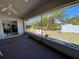 Relaxing screened porch with backyard view; lush greenery beyond the white privacy fence at 21342 Walling Ct, Port Charlotte, FL 33954