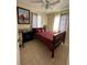 A comfy bedroom offers a bed and window views at 22191 Augusta Ave, Port Charlotte, FL 33952