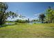 Scenic backyard view overlooking a tranquil waterway with lush greenery at 2230 Harbor Blvd, Port Charlotte, FL 33952