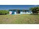 Backyard featuring blue exterior with a grassy area perfect for outdoor activities at 2230 Harbor Blvd, Port Charlotte, FL 33952