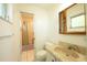 Bathroom with a vanity and a tiled floor, complemented by a framed mirror and shower at 2230 Harbor Blvd, Port Charlotte, FL 33952