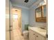 Bathroom with a sink, a framed mirror, and access to a shower for convenience at 2230 Harbor Blvd, Port Charlotte, FL 33952