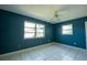 Simple bedroom featuring tile flooring, light and bright windows and neutral ceiling fan at 2230 Harbor Blvd, Port Charlotte, FL 33952