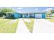 Charming one story home with a teal exterior, attached garage and inviting entryway at 2230 Harbor Blvd, Port Charlotte, FL 33952