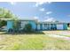 Inviting one story home with attached garage, covered entry and bright teal colored siding at 2230 Harbor Blvd, Port Charlotte, FL 33952