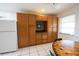 Kitchen with lots of cabinets and a white refrigerator, offering ample storage and modern appliances at 2230 Harbor Blvd, Port Charlotte, FL 33952