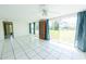 Bright living room with tile flooring, expansive windows showcasing the outdoors at 2230 Harbor Blvd, Port Charlotte, FL 33952