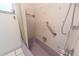 Shower with tiled walls and a grab bar, offers a safe and comfortable bathing experience at 2230 Harbor Blvd, Port Charlotte, FL 33952